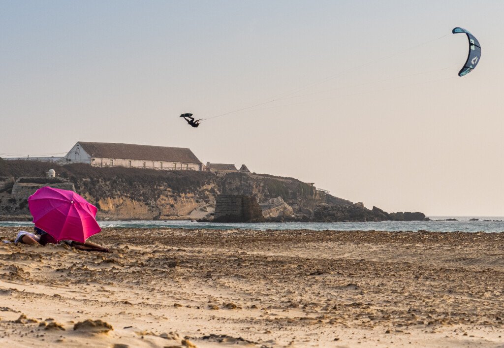 Alumno realizando un gran salto con el kite en el famoso spot El Balneario de Tarifa durante un curso de kitesurf